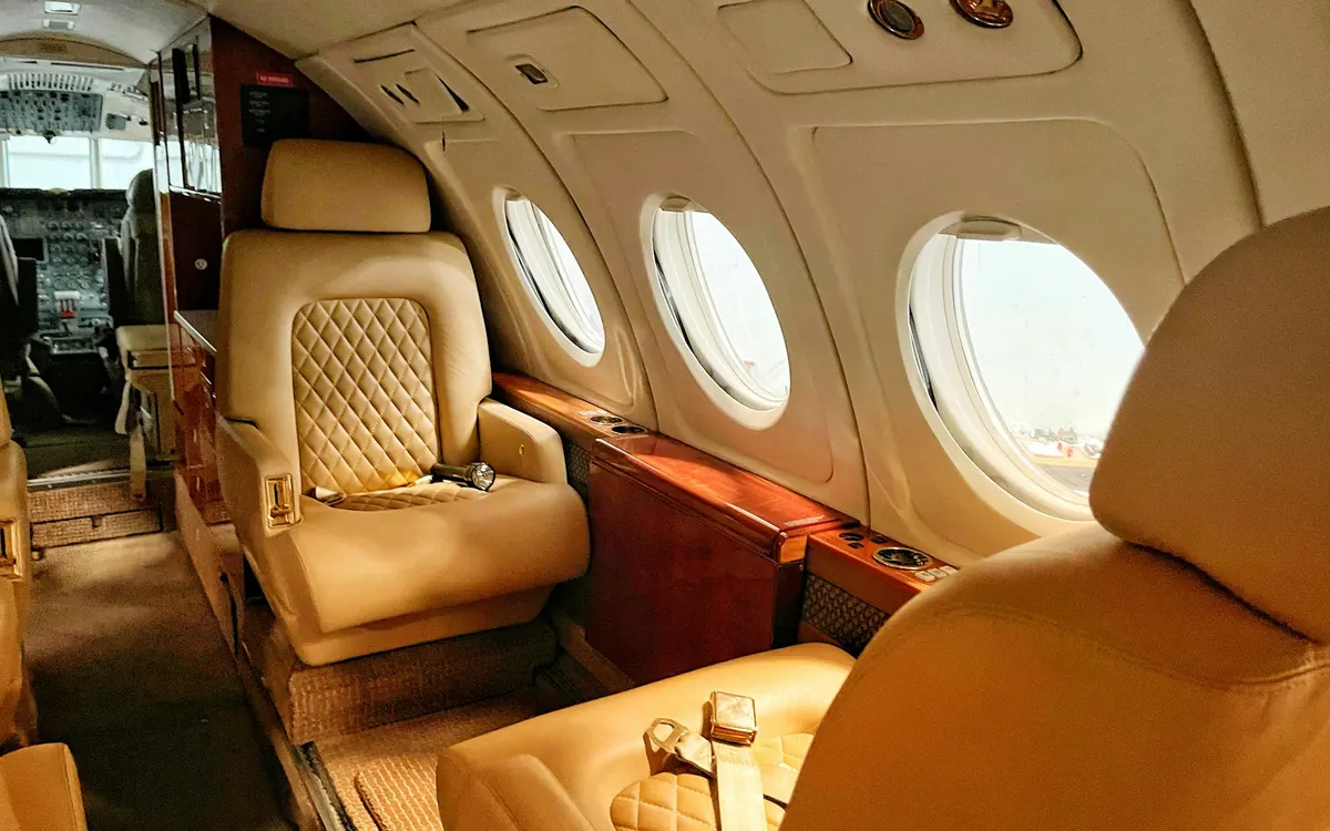 Cream leather seats with quilted backrests in a private jet cabin